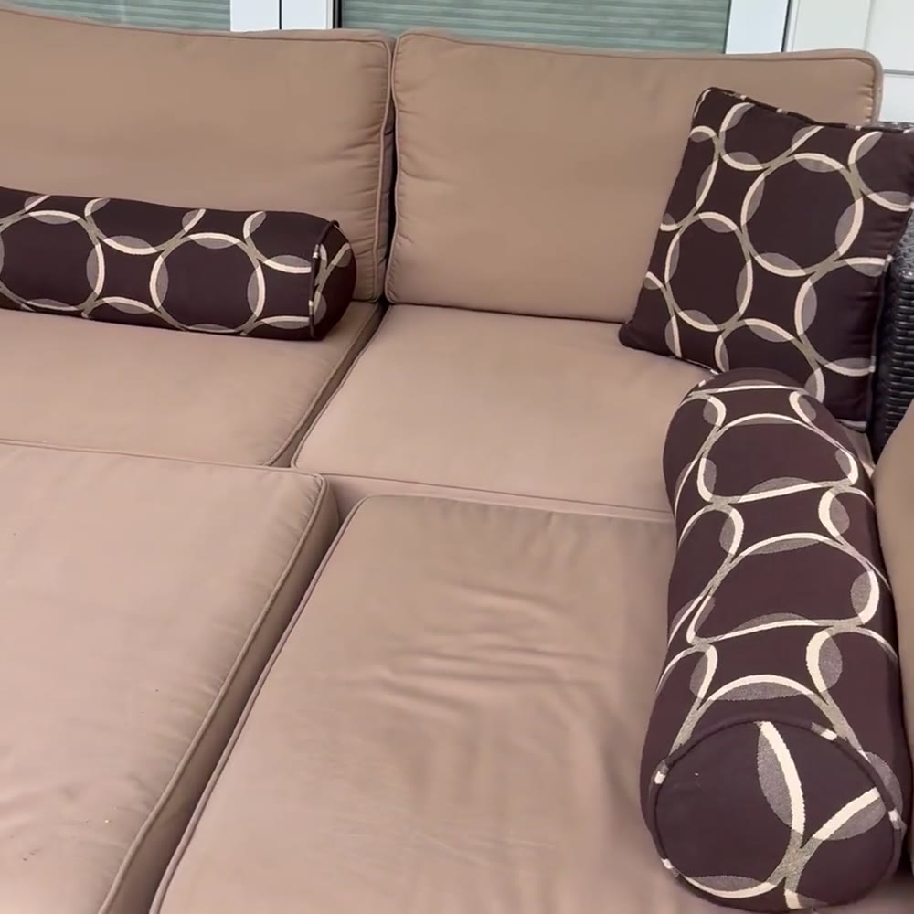 Beige patio sectional with patterned bolster pillows after an Avelo visit
